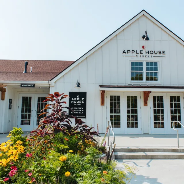 Apple House Market building featuring a charming exterior with inviting outdoor seating.