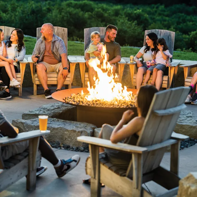 Family sitting around campfire