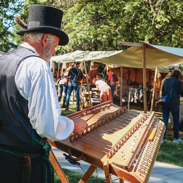 Man playing instrument at living history weekend