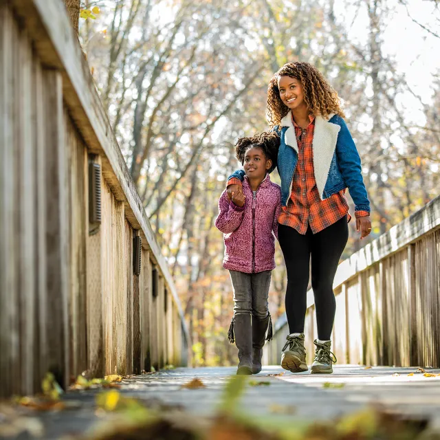 Mom and Daughter walking along the bridge on Doug's Trail
