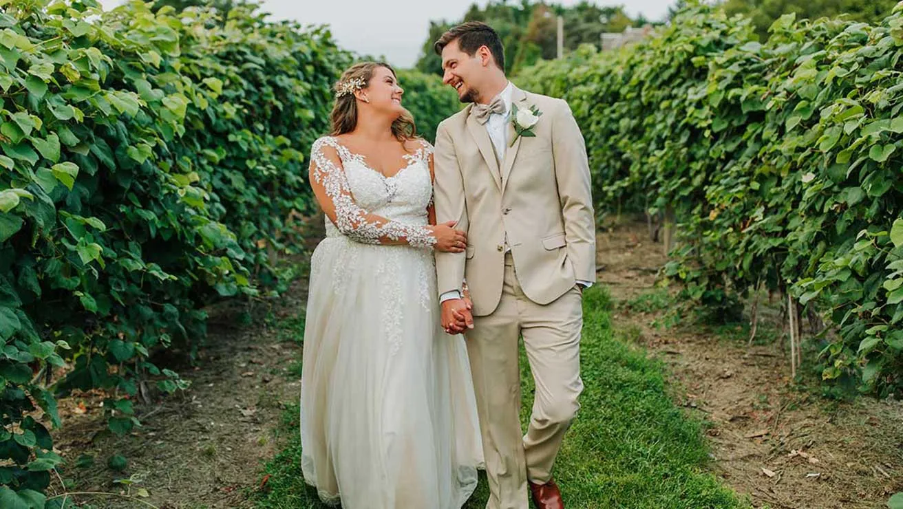 Couple walking through the vineyard