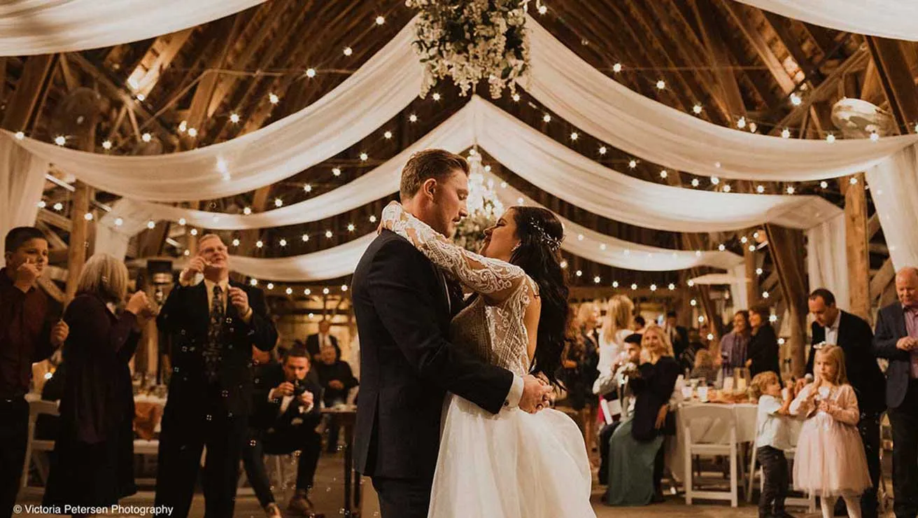 Wedding couple dancing in barn