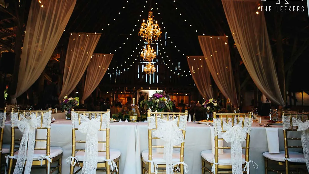 Head table at wedding reception in barn